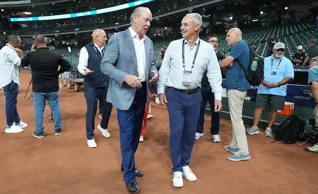 Houston Astros owner Jim Crane, left, talks with MLB Commissioner Rob Manfred, right, before Game 1 of baseball's American League Wild Card Series against the Chicago White Sox, Tuesday, Sept. 29, 2026, in Houston. (AP Photo/Karen Warren