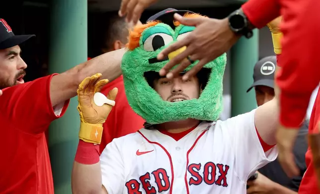 Boston Red Sox's Caleb Durbin celebrates in the dugout after his solo home run during the second inning of a baseball game against the Kansas City Royals, Sunday, Sept. 13, 2026, in Boston. (AP Photo/Mark Stockwell)