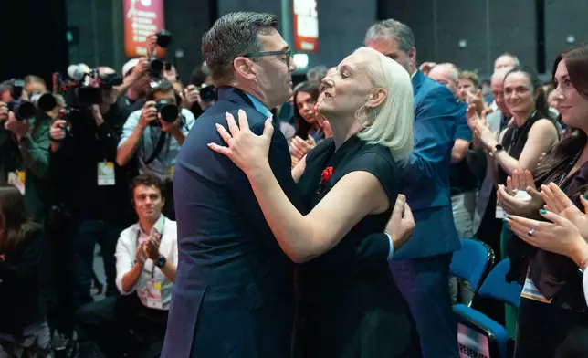 Britain's Prime Minister Andy Burnham embraces his wife Marie France Van Heel after delivering his keynote speech at the Labour Party Conference, in Liverpool, England, Tuesday, Sept. 29, 2026. (Stefan Rousseau/Pool Photo via AP)