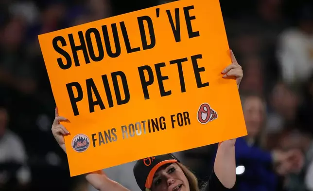 A fan holds up a sign during the eleventh inning of a baseball game between the New York Mets and the Baltimore Orioles, Tuesday, Sept. 15, 2026, in New York. (AP Photo/Seth Wenig)