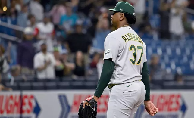 Athletics pitcher Elvis Alvarado walks off the field after giving up a a walk-off home run to Tampa Bay Rays' Junior Caminero during the ninth inning of a baseball game Tuesday, Sept. 15, 2026, in St. Petersburg, Fla. (AP Photo/Jason Behnken)