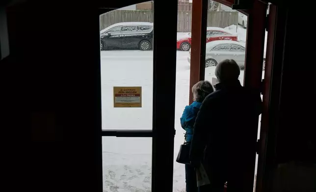Signs saying that immigration agents have no right to enter without a warrant are posted on the doors of Holy Trinity Lutheran Church in Minneapolis on Sunday, Jan. 18, 2026. (AP Photo/Giovanna Dell'Orto)