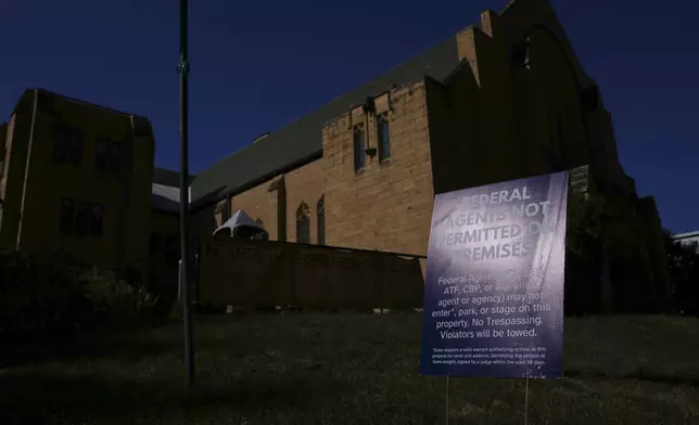 A sign prohibiting federal agents from entering the premises is posted outside University Baptist Church, Friday, Sept. 4, 2026, in Minneapolis. (AP Photo/Ellen Schmidt)