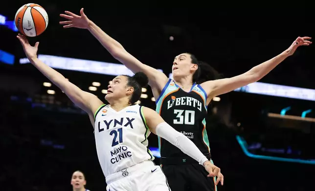 Minnesota Lynx guard Kayla McBride (21) drives to the basket past New York Liberty forward Breanna Stewart (30) during the first half of Game 2 of a WNBA basketball first-round playoff series, Tuesday, Sept. 29, 2026, in New York. (AP Photo/Heather Khalifa)
