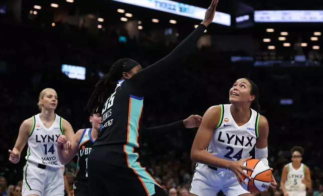 Minnesota Lynx forward Napheesa Collier (24) looks to shoot over New York Liberty center Jonquel Jones (35) during the first half of Game 2 of a WNBA basketball first-round playoff series, Tuesday, Sept. 29, 2026, in New York. (AP Photo/Heather Khalifa)