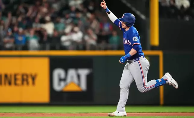 Texas Rangers' Danny Jansen jogs the bases after hitting a three-run home run against the Seattle Mariners during the fifth inning of a baseball game, Tuesday, Sept. 8, 2026, in Seattle. (AP Photo/Lindsey Wasson)