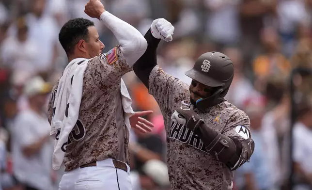 San Diego Padres' Luis Campusano, right, celebrates with Manny Machado after hitting a home run during the seventh inning of a baseball game against the New York Yankees Sunday, Sept. 6, 2026, in San Diego. (AP Photo/Gregory Bull)