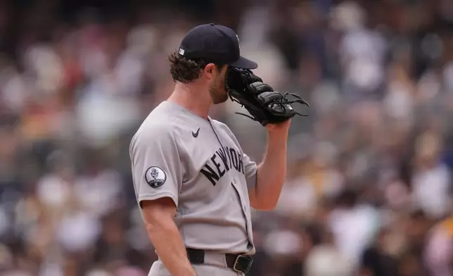 New York Yankees starting pitcher Gerrit Cole wipes his face with his glove after giving up three home runs during the first inning of a baseball game against the San Diego Padres Sunday, Sept. 6, 2026, in San Diego. (AP Photo/Gregory Bull)