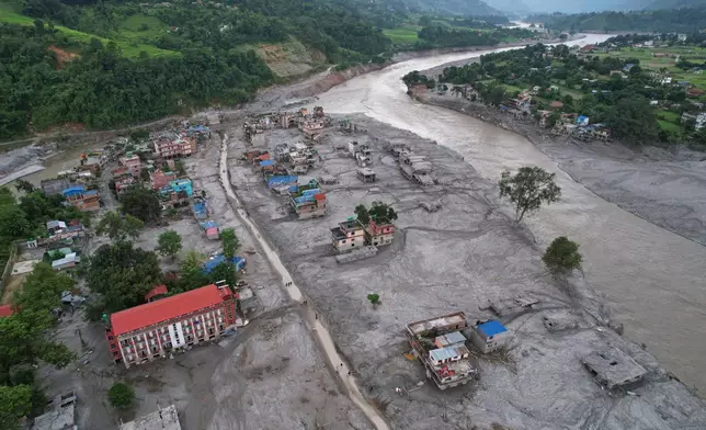 FILE - Homes are engulfed in mud in the aftermath of flash flooding along the Trishuli River in the Devighat area of Nuwakot district, Nepal, Aug. 29, 2026. (AP Photo/Rajesh Kumar Singh, File)
