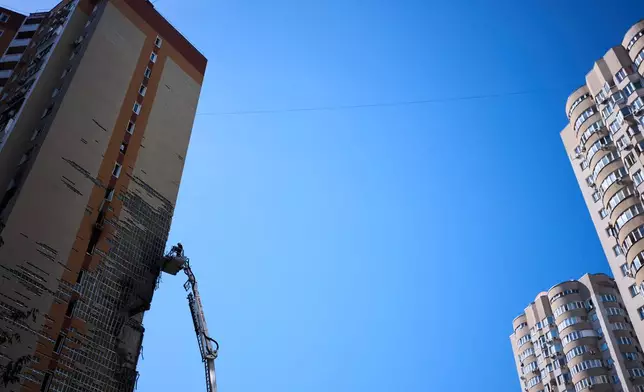Firefighters work on a partially damaged residential building following a Russian drone attack in Kyiv, Ukraine, Wednesday, Sept. 9, 2026. (AP Photo/Francisco Seco)