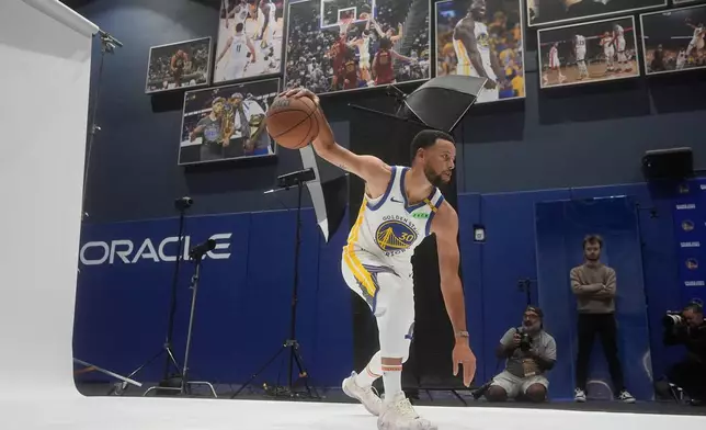 Golden State Warriors guard Stephen Curry poses for photos during the NBA basketball team's media day, Monday, Sept. 28, 2026, in San Francisco. (AP Photo/Jeff Chiu)