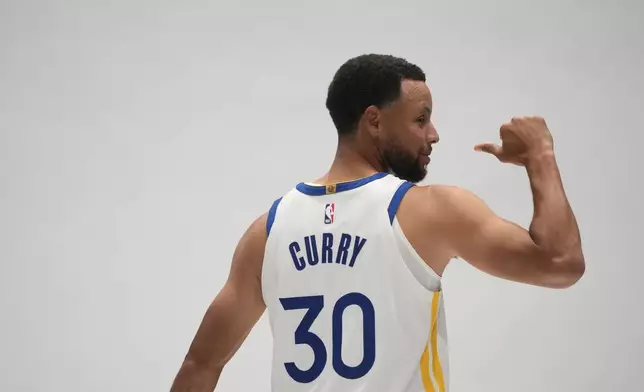 Golden State Warriors guard Stephen Curry poses for photos during the NBA basketball team's media day, Monday, Sept. 28, 2026, in San Francisco. (AP Photo/Jeff Chiu)