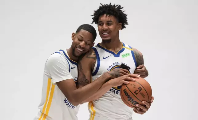 Golden State Warriors forward Dalen Terry, left, hugs forward Yaxel Lendeborg during the NBA basketball team's media day, Monday, Sept. 28, 2026, in San Francisco. (AP Photo/Jeff Chiu)