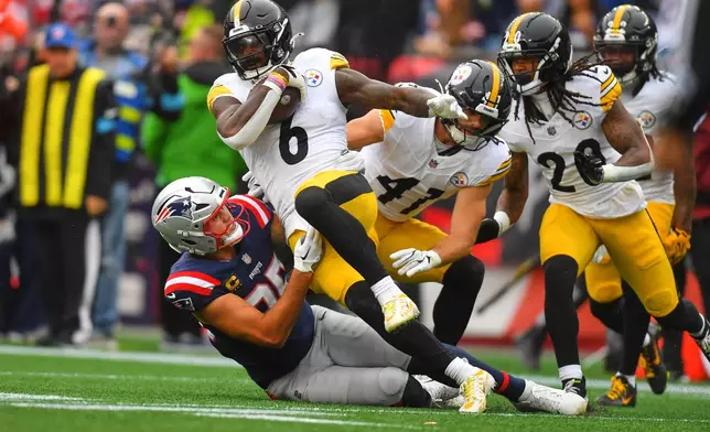 Pittsburgh Steelers' Patrick Queen (6) is tackled after intercepting a pass during the second half of an NFL football game in Foxborough, Mass., Sunday, Sept. 20, 2026. (AP Photo/Steven Senne)