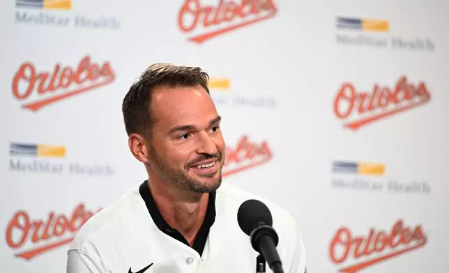 Former Baltimore Oriole Trey Mancini smiles before signing a one day contract with Baltimore Orioles and returning to the team as he announces his retirement during a news conference on Saturday, Sept. 19, 2026 in Baltimore. (AP Photo/Gail Burton)