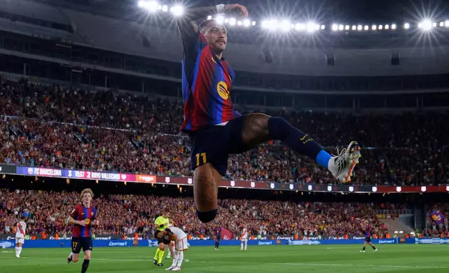 Barcelona's Raphinha celebrates after scoring his side's fourth goal during a Spanish La Liga soccer match between Barcelona and Rayo Vallecano in Barcelona, Spain, Monday, Aug. 31, 2026. (AP Photo/Joan Monfort)