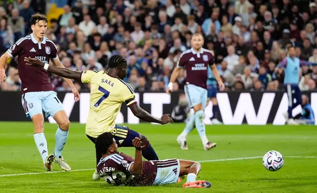 Arsenal's Bukayo Saka (7) scores his side's opening goal during the English Premier League soccer match between Aston Villa and Arsenal in Birmingham, England, Monday, Aug. 31, 2026. (Nick Potts/PA via AP)