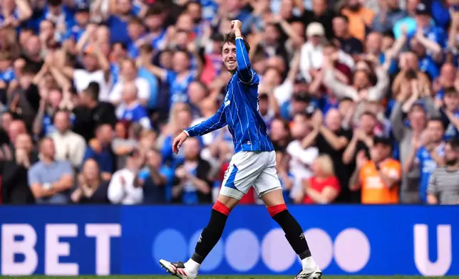 Rangers' Daniel Neil celebrates scoring their side's third goal during the Scottish League Cup soccer match between Rangers and Celtic, in Glasgow, Sunday Sept. 13, 2026. (Andrew Milligan/PA via AP)
