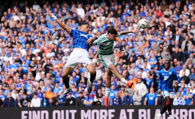 Rangers' Kevin Kelsy (left) and Celtic's Colby Donovan battle for the ball during the Scottish League Cup soccer match between Rangers and Celtic, in Glasgow, Sunday Sept. 13, 2026. (Andrew Milligan/PA via AP)