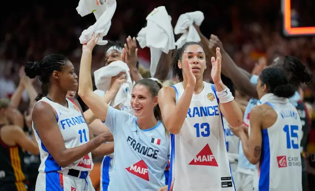 French players celebrate after the Women's Basketball World Cup semifinal match between France and Germany in Berlin, Saturday, Sept. 12, 2026. (AP Photo/Ebrahim Noroozi)