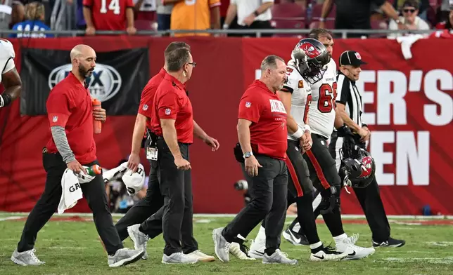 Tampa Bay Buccaneers quarterback Baker Mayfield (6) walks off the field after sustaining an injury during the second half of an NFL football game against the Minnesota Vikings in Tampa, Fla., Sunday, Sept. 27, 2026. (AP Photo/Jason Behnken)