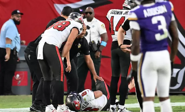Tampa Bay Buccaneers quarterback Baker Mayfield (6) lays on the ground after sustaining an injury during the second half of an NFL football game against the Minnesota Vikings in Tampa, Fla., Sunday, Sept. 27, 2026. (AP Photo/Jason Behnken)