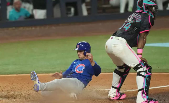 Chicago Cubs' Alex Bregman scores on a sacrifice fly hit by Pedro Ramirez during the sixth inning of a baseball game against the Miami Marlins Friday, Sept. 4, 2026, in Miami. (AP Photo/Marta Lavandier)