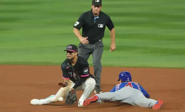 Chicago Cubs' Pete Crow-Armstrong (4) steal second base as Miami Marlins second baseman Jared Serna is late with the tag during the sixth inning of a baseball game Friday, Sept. 4, 2026, in Miami. (AP Photo/Marta Lavandier)