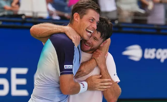 Neal Skupski, of Britain, left, celebrates with Christian Harrison, of the United States, right, after winning the men's doubles final of the U.S. Open tennis championships Kevin Krawietz, of Germany, and Tim Puetz, of Germany, Saturday, Sept. 12, 2026, in New York. (AP Photo/Kirsty Wigglesworth)