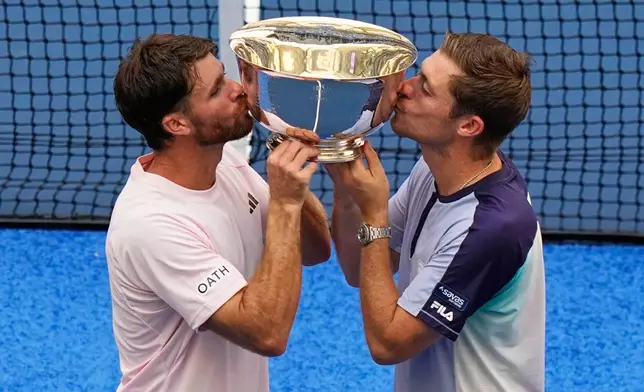 Christian Harrison, of the United States, left, and Neal Skupski, of Britain, right, pose for a photo with their trophy after winning the men's doubles final of the U.S. Open tennis championships against Kevin Krawietz, of Germany, and Tim Puetz, of Germany, Saturday, Sept. 12, 2026, in New York. (AP Photo/Frank Franklin II)