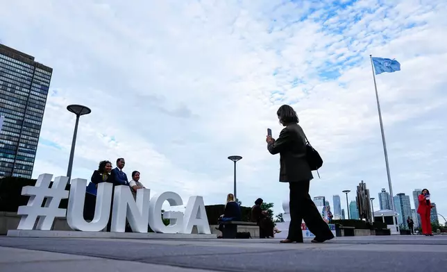 People pose as they arrive for the United Nations General Assembly (UNGA) at the UN headquarters, Monday, Sept. 21, 2026. (Justin Tang/The Canadian Press via AP)