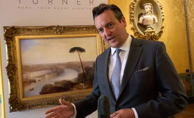Julian Gascoigne, senior specialist in British paintings at Sotheby's London, explains J.M.W. Turner's 1836 painting "Rome, from Mount Aventine," in the background, estimated at around 50 million pounds ($67 million), to journalists in Rome, Tuesday, Sept. 29, 2026, during a press preview at Palazzo Rondinini ahead of its auction by Sotheby's in London on Dec. 9. (AP Photo/Domenico Stinellis)