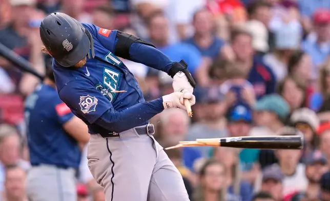 Seattle Mariners' Taylor Ward breaks his bat on a ground out in the fifth inning of a baseball game against the Boston Red Sox, Wednesday, Sept. 2, 2026, in Boston. (AP Photo/Charles Krupa)