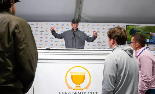 International teams' Adam Scott, of Australia, speaks prior to the start of the Presidents Cup golf tournament against the USA team at Medinah Country Club, Tuesday, Sept. 22, 2026, in Medinah, Ill. (AP Photo/Matt Slocum)