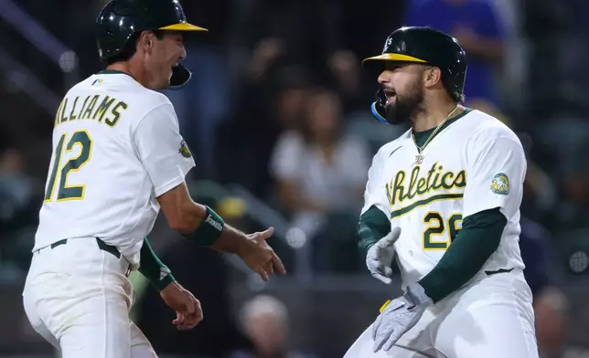 Athletics' Carlos Cortes, right, celebrates with teammate Alika Williams (12) after hitting a go ahead two-run home run during the eighth inning of a baseball game against the Los Angeles Angels Tuesday, Sept. 22, 2026, in West Sacramento, Calif. (AP Photo/Scott Marshall)