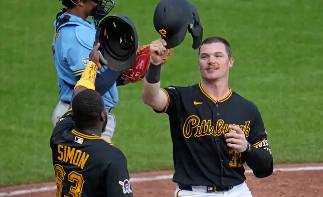 Pittsburgh Pirates' Henry Davis, right, celebrates with Ronny Simon (63) after hitting a two-run home run in the eighth inning of a baseball game against the Milwaukee Brewers in Pittsburgh, Thursday, Sept. 17, 2026. (AP Photo/Gene J. Puskar)