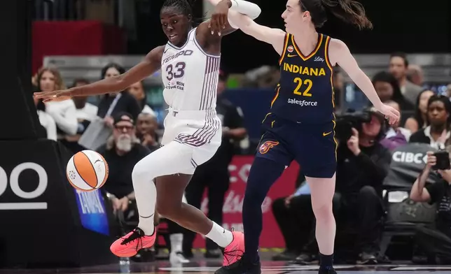 Toronto Tempo's Ornella Bankole (33) steals the ball from Indiana Fever's Caitlin Clark (22) during first half WNBA basketball action in Toronto on Friday, Sept. 18, 2026. (Nathan Denette/The Canadian Press via AP)