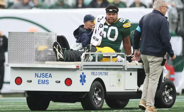 Green Bay Packers guard Zach Bako-Bewele (50) is taken off the field following an injury during an NFL football game against the New York Jets in East Rutherford, N.J., Sunday, Sept. 20, 2026. (AP Photo/Adam Hunger)