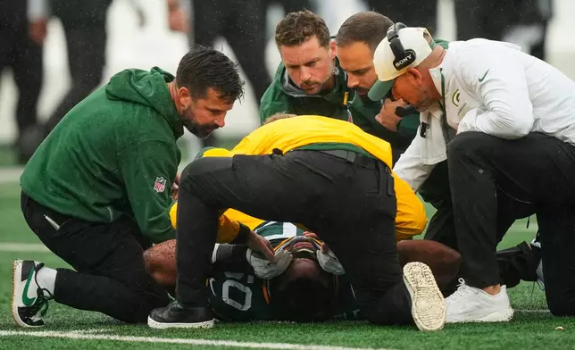 Green Bay Packers guard Zach Bako-Bewele (50) is tended to on the field during an NFL football game against the New York Jets in East Rutherford, N.J., Sunday, Sept. 20, 2026. (AP Photo/Yuki Iwamura)