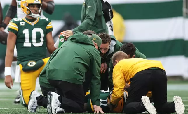 Green Bay Packers wide receiver Jayden Reed (11) is tended to on the field during an NFL football game against the New York Jets in East Rutherford, N.J., Sunday, Sept. 20, 2026. (AP Photo/Adam Hunger)