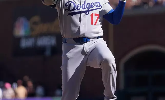 Los Angeles Dodgers designated hitter Shohei Ohtani gestures after hitting a single during the fifth inning of a baseball game against the San Francisco Giants, Saturday, Sept. 26, 2026, in San Francisco. (AP Photo/Jeff Chiu)