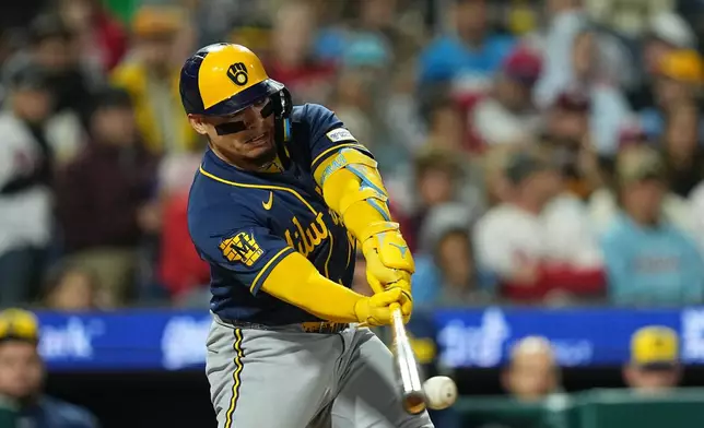 Milwaukee Brewers' William Contreras hits a two-run single off of Philadelphia Phillies pitcher Aaron Nola during the third inning of a baseball game, Wednesday, Sept. 23, 2026, in Philadelphia. (AP Photo/Matt Rourke)