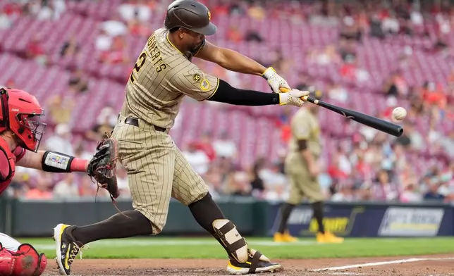 San Diego Padres' Xander Bogaerts hits a double to score Ty France, and Jackson Merrill, as Cincinnati Reds catcher Tyler Stephenson is left, during the fourth inning of a baseball game in Cincinnati, Monday, Aug. 31, 2026. (AP Photo/Carolyn Kaster)
