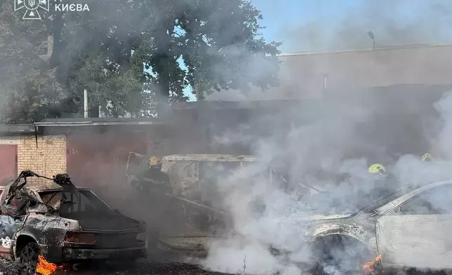 In this photo provided by the Ukrainian Emergency Service, firefighters put out a fire involving private vehicles following a Russian air attack in Kyiv, Ukraine, Wednesday, Sept. 16, 2026. (Ukrainian Emergency Service via AP)
