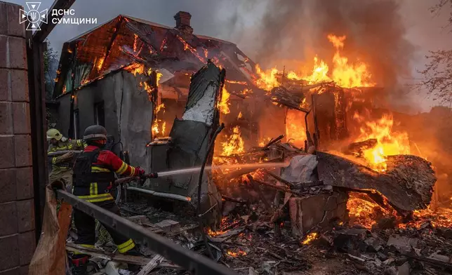 In this photo provided by the Ukrainian Emergency Service, firefighters put out a fire at private homes following a Russian air attack in Sumy, Ukraine, Wednesday, Sept. 16, 2026. (Ukrainian Emergency Service via AP)