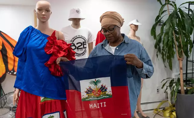 Haitian-born Edwina Paul holds Haitian flag ahead of the West Indian Day Parade, Thursday, Sept. 3, 2026, in the Brooklyn borough of New York. (AP Photo/Adam Gray)