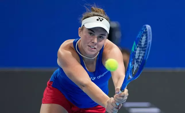Linda Noskova of Czech Republic returns the ball to Katie Boulter of Britain in a quarterfinal match for the Billie Jean King Cup held in Shenzhen in southern China's Guangdong province, Tuesday, Sept. 22, 2026. (AP Photo/Andy Wong)