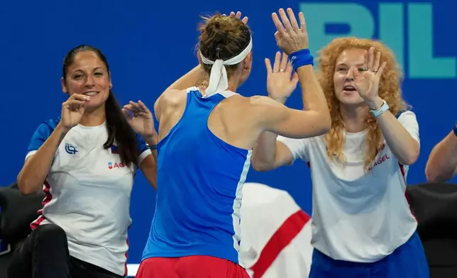 Marie Bouzkova of Czech Republic, center celebrates with her team after defeating Sonay Kartal of Britain in a quarterfinal match for the Billie Jean King Cup held in Shenzhen in southern China's Guangdong province, Tuesday, Sept. 22, 2026. (AP Photo/Andy Wong)