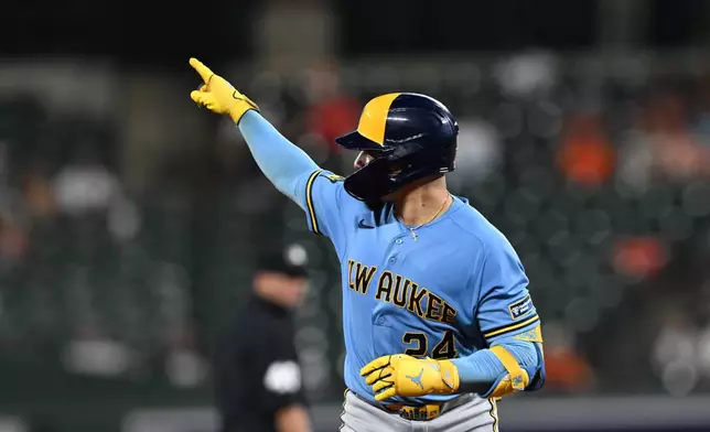 Milwaukee Brewers catcher William Contreras (24) points after hitting a solo home run against the Baltimore Orioles in the fourth inning of a baseball game, Sunday, Sept. 20, 2026, in Baltimore. (AP Photo/Gail Burton)