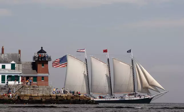 FILE - The Victory Chimes passes the Rockland Breakwater Lighthouse during the Maine Windjammer Parade, July 17, 2009, in Rockland, Maine. (AP Photo/Robert F. Bukaty, File)